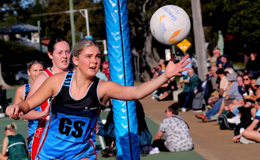 University of Newcastle goal shooter Millie Tonkin reaches for a rebound. Picture by Peter Lorimer