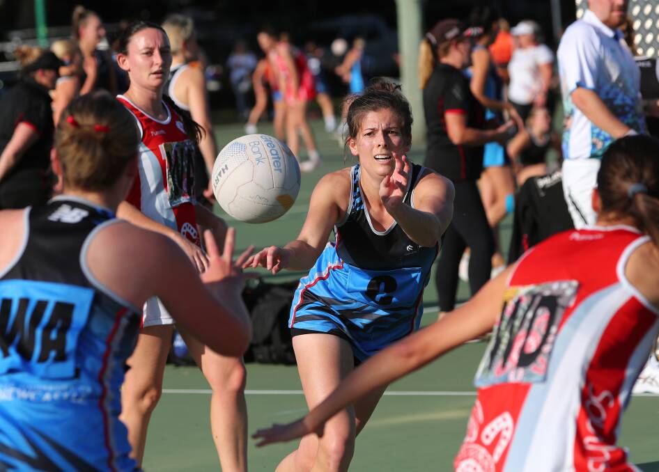 University of Newcastle centre Karli Quinn gets a pass away against Souths at National Park netball courts on Saturday. Picture by Peter Lorimer