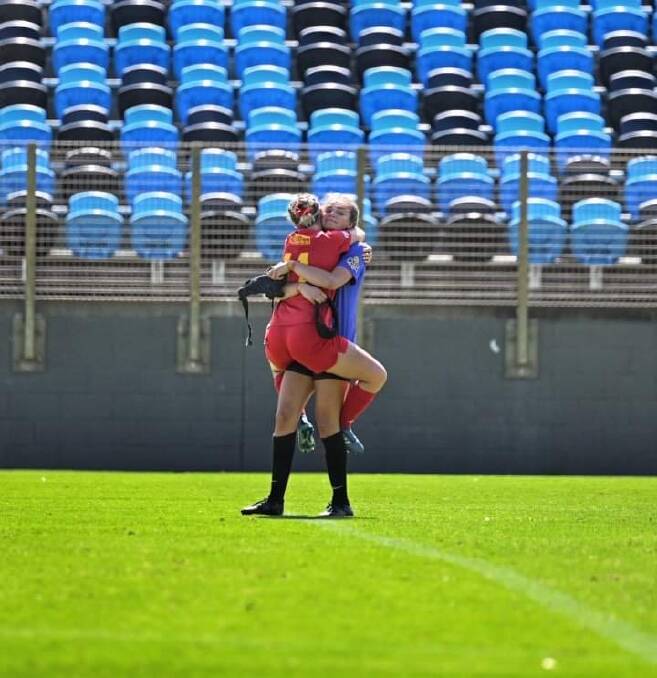 This picture says it all as Ruby Jones and sister Ellie share an embrace after Ruby's first game back in action following a major injury setback. Picture: Todd Blackwell