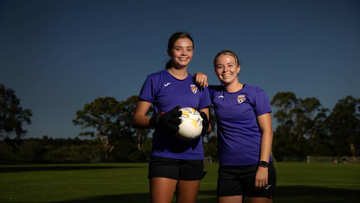 STRONG SUPPORT: Broadmeadow goalkeeper Ruby Jones, left, with older sister and Magic teammate Ellie. Picture: Marina Neil