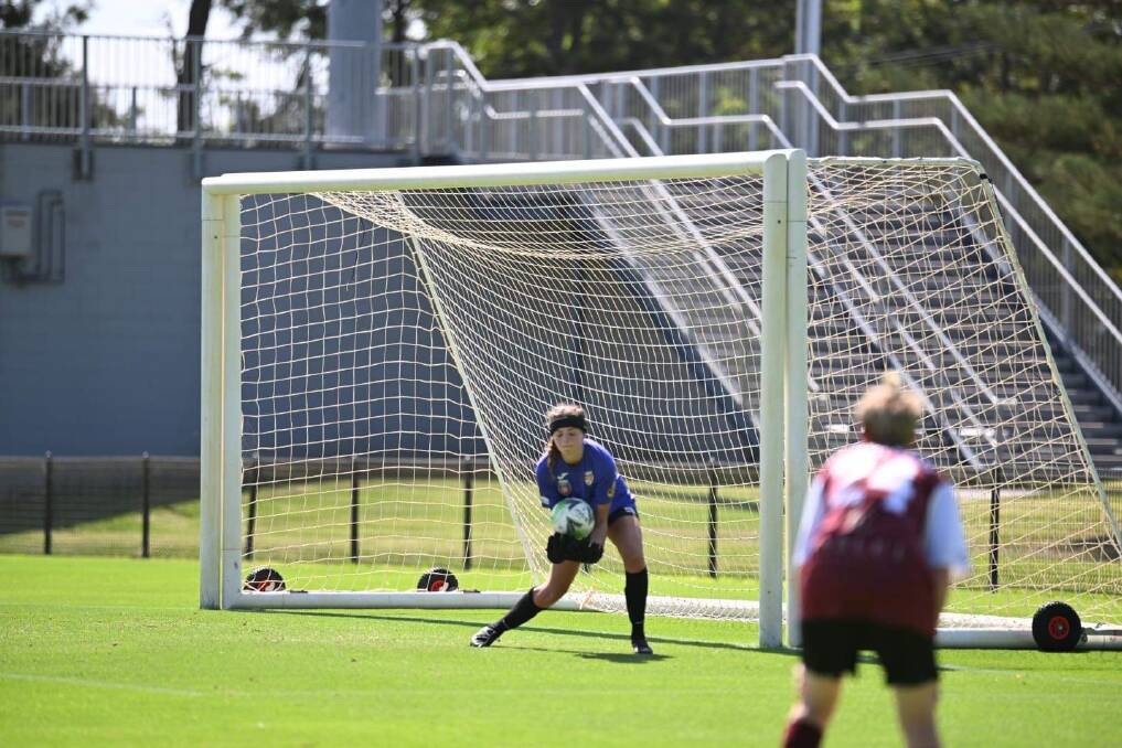 Goalkeeper Ruby Jones, who now wears a protective headband while playing, makes a save in her return in a trial match for Broadmeadow on January 29. Picture: Todd Blackwell