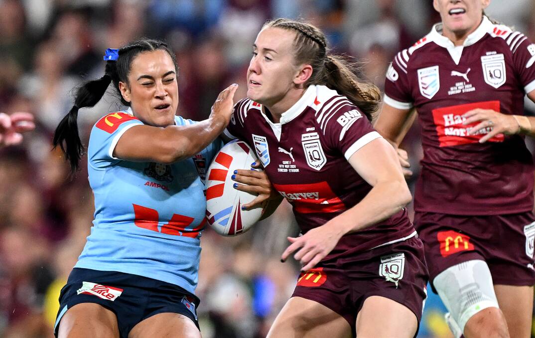 NSW back-rower Yasmin Clydsdale runs into Queensland fullback Tamika Upton in Origin I. Picture Getty Images
