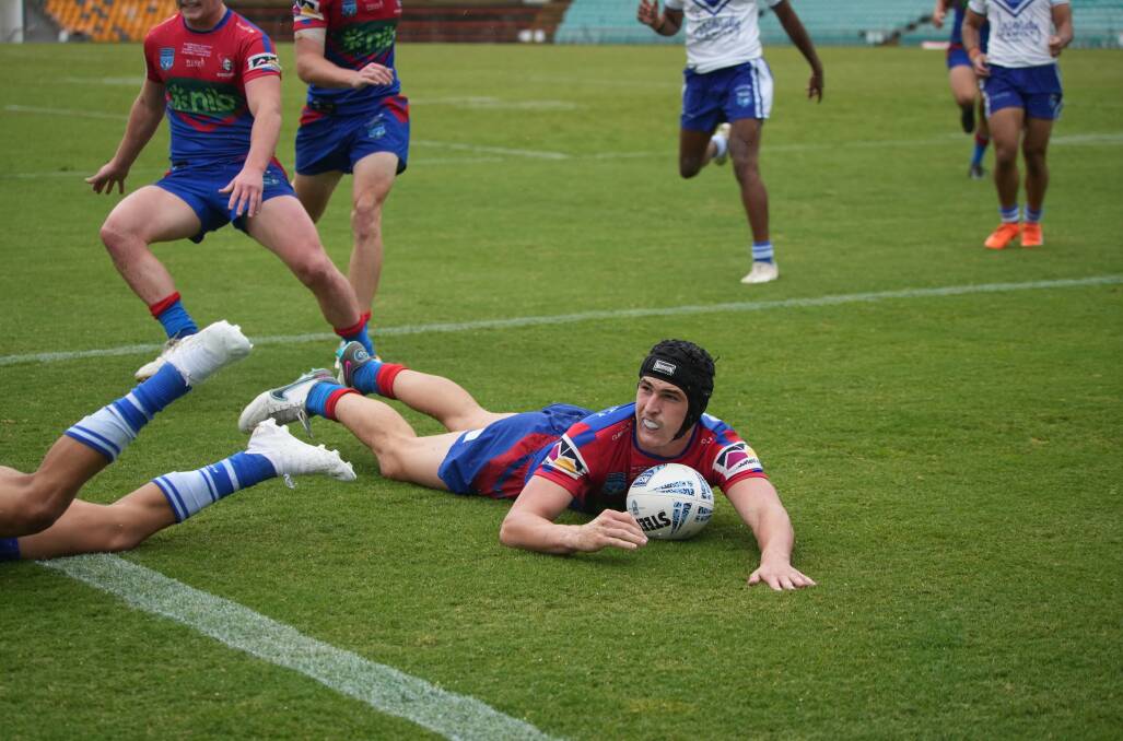 Votano slides in for the first try. Picture by James Ward/Newcastle Knights 