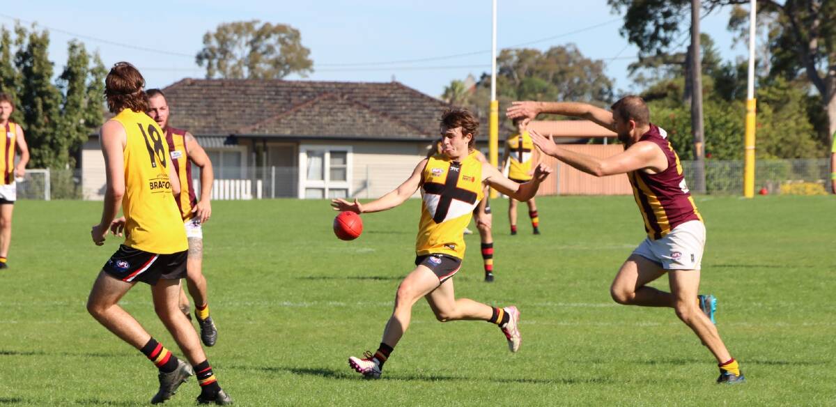 Maitland's Cooper Daniel gets a kick away against Cardiff at Max McMahon Oval on Saturday. Picture Maitland Saints/Facebook