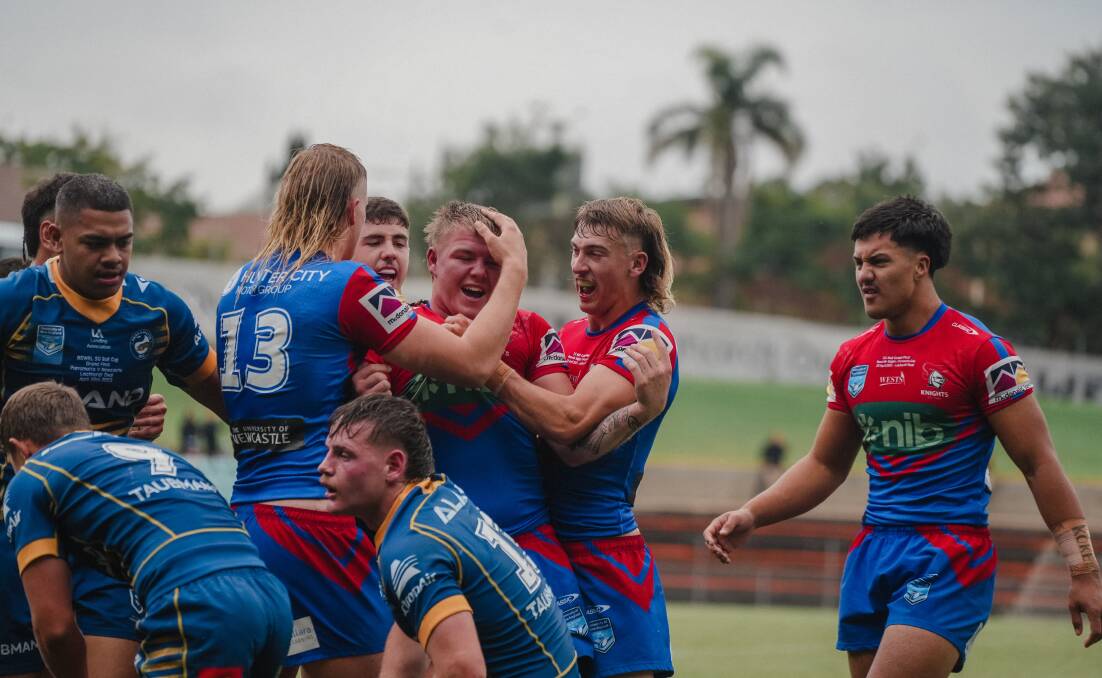 Knights players celebrate Slade's try. Picture by James Ward/Newcastle Knights
