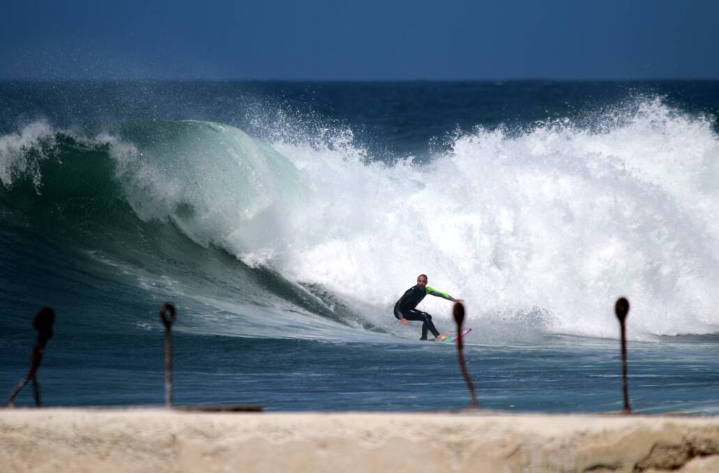 SWELL: A surfer at The Alley in Newcastle on Tuesday. Picture: Dave Anderson