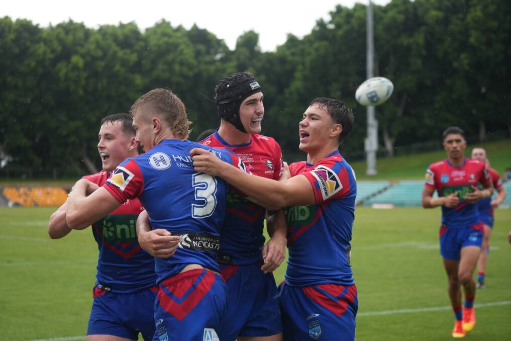 Newcastle players celebrate Votano's first-half try. Picture by James Ward/Newcastle Knights 