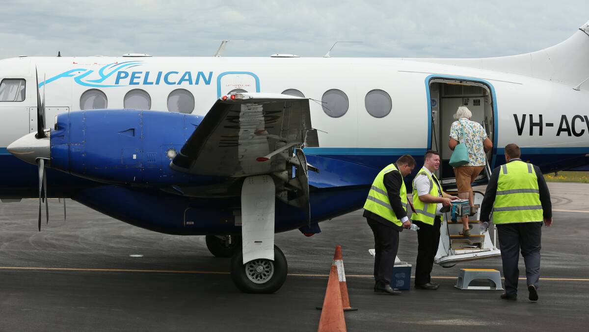 HOLIDAY: Elizabeth Riley steps into the FlyPelican plane. Picture: Simone De Peak