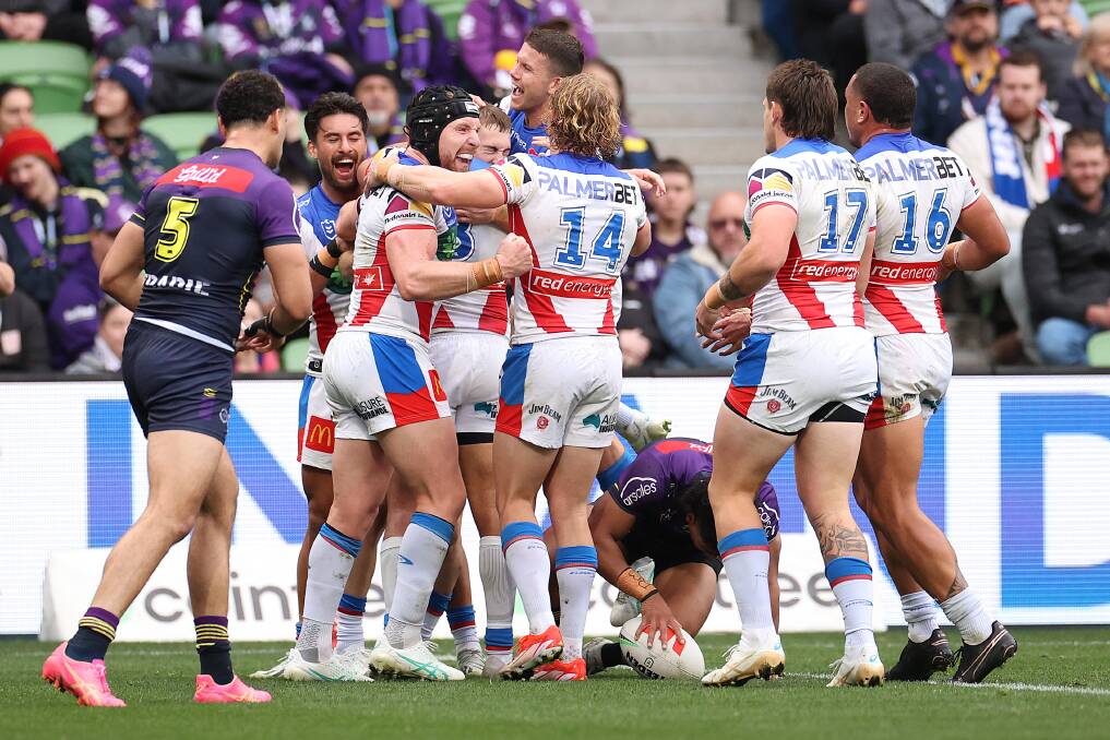 Knights players rally around Fletcher Sharpe after the fullback's maiden try. Picture Getty Images 