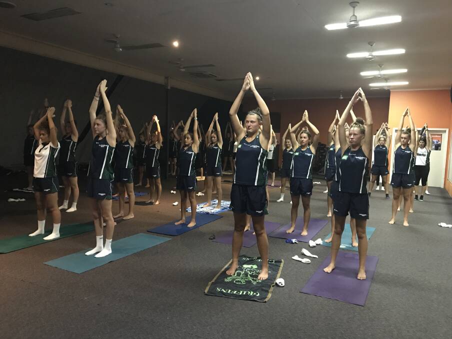 FRESH KNOWLEDGE: The Hunter Academy of Sport's netball squad during a yoga session last week. The session came on the back of a new gym partnership. 