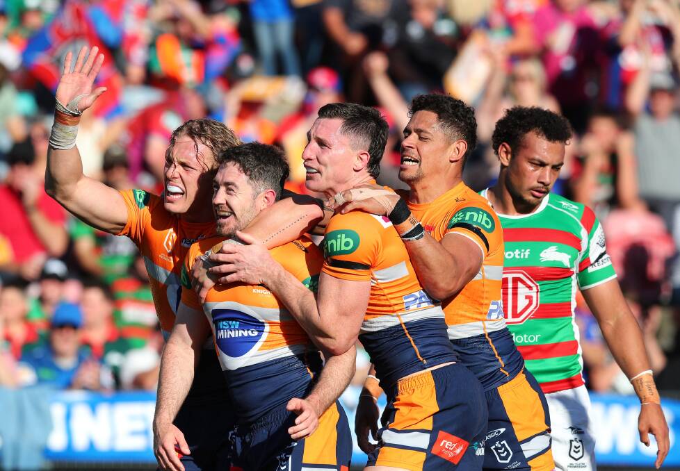 Knights players mob Adam Clune after his try on Sunday. Picture by Peter Lorimer