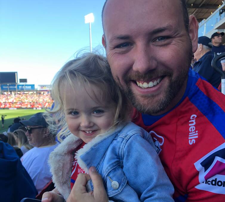 Sky Taylor, 2, has just learnt to shout "go Knights!" and was at the game with her dad, Newcastle rugby league referee Tom Taylor, last weekend to see the Knights women secure a spot in the NRLW grand final.