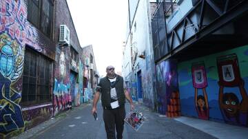 Street artist Chris Butler at work on Beresford Lane in Newcastle. Picture by Peter Lorimer