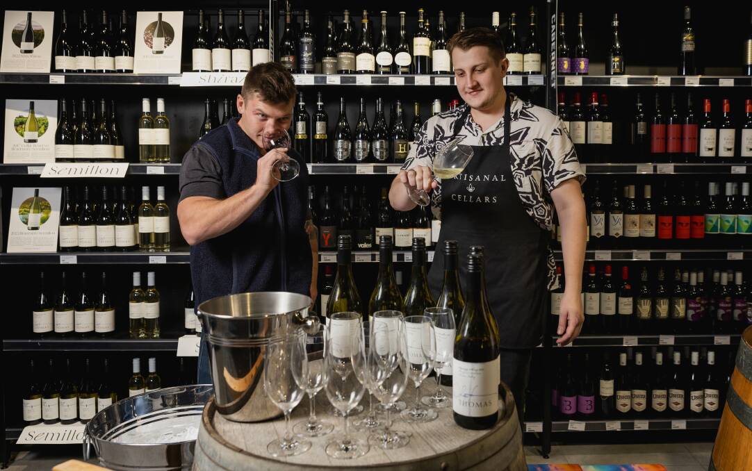 Daniel Thomas, the son of premier Hunter winemaker Andrew Thomas, joins leading wine retailer Charlie Kempe's impromptu cellar door tasting at Artisanal Cellars on Hunter Street. Picture by Marina Neil