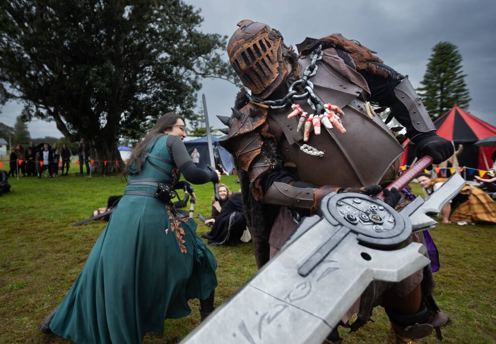 Rosa Chapperri takes on the half-orc Nibbles in the Swordcraft and Battlecry LARP display at Pop Bam in Lake Macquarie on Saturday, July 27. Picture by Simon McCarthy 