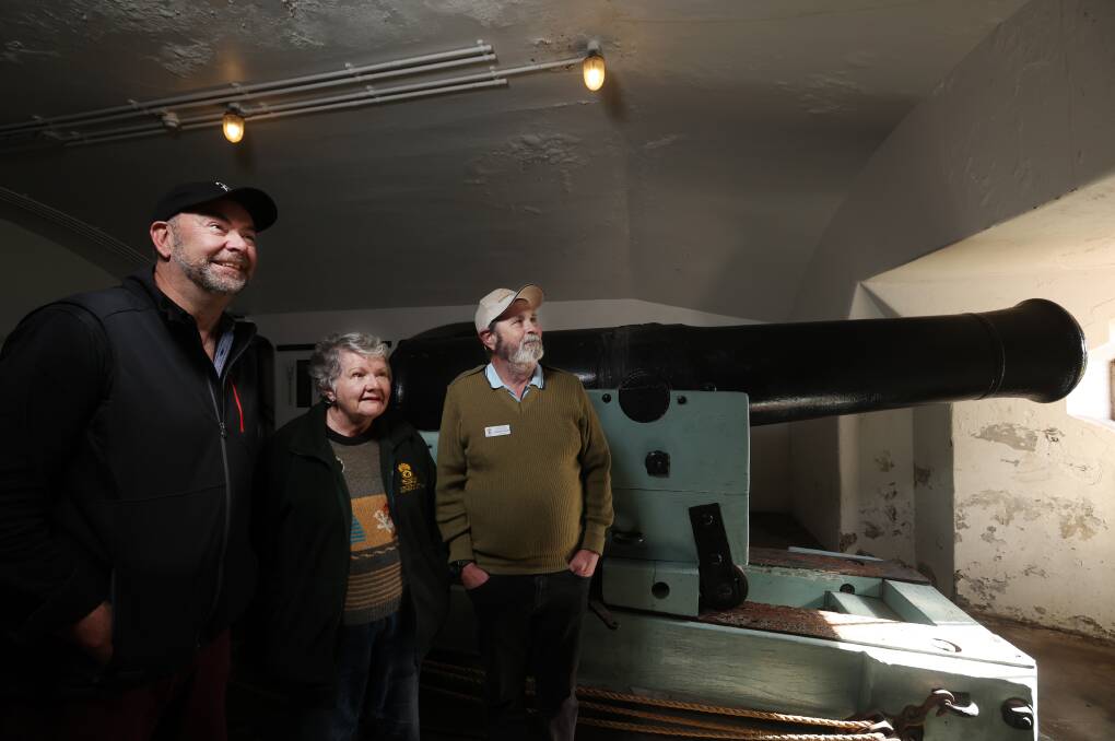 Marty Adnum, Mary Tarrant and Stephen Shaw inside the 80 Pounder Case Mate Room with a 80 pounder R.M.L Gun at Fort Scratchley. Picture by Simone De Peak