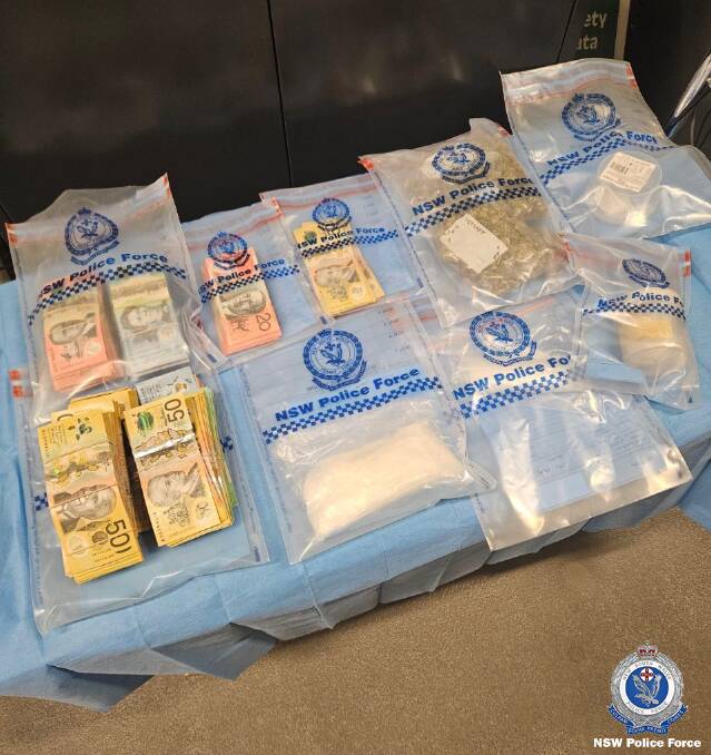 A quantity of seized cash and drugs allegedly taken during a search at Broken Hill.