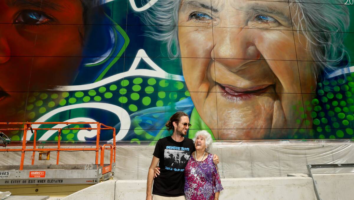 CAPTURING TIME: Melbourne artist Matt Last, known as "Adnate", and Aunty June Rose in front of her portrait. Picture: Jonathan Carroll 