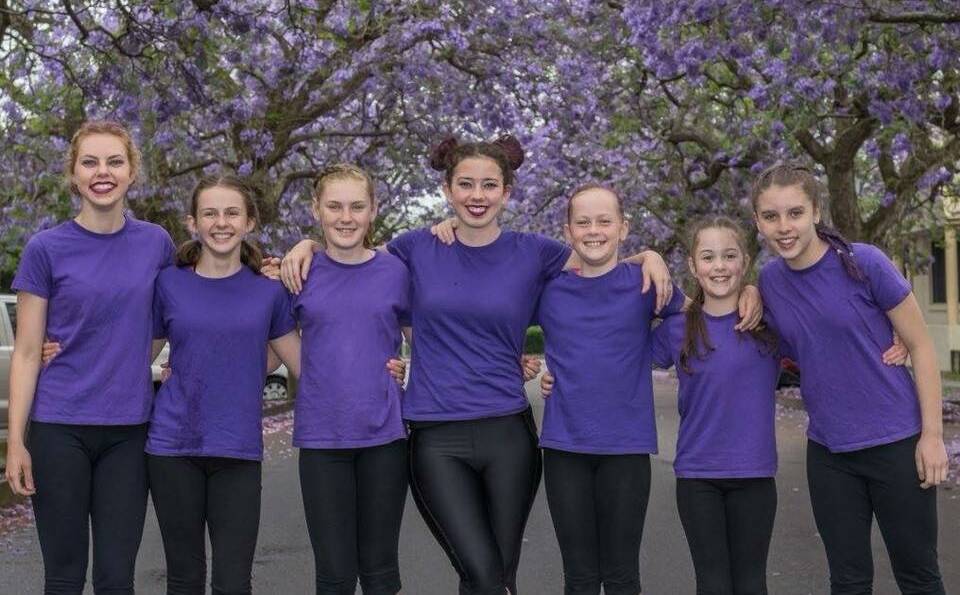 GYM CLUB: Young-business owner Samantha Nicholls (centre) with Gymnastics 21's competitive team. Picture: Supplied