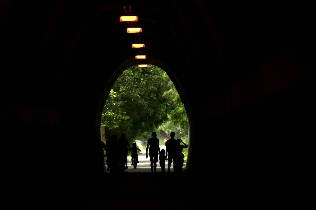 Walkers using the Fernleigh Track tunnel. 