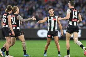 Magpie Nick Daicos (second right) kicked a goal but was injured late in the win over the Demons. (James Ross/AAP PHOTOS)