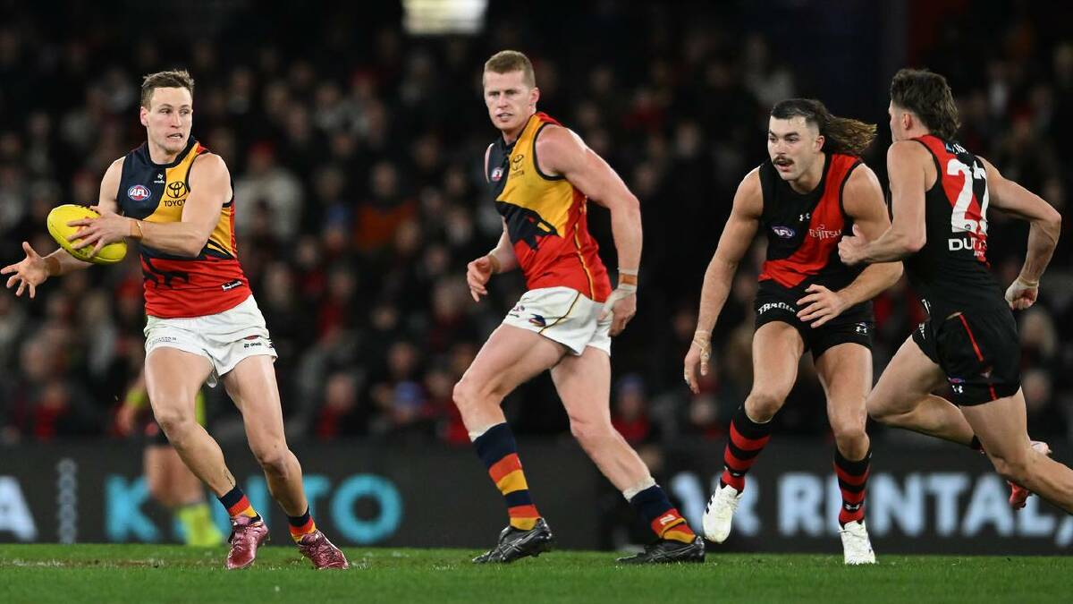 Jordan Dawson (l) copped a high knock playing against Essendon. (James Ross/AAP PHOTOS)