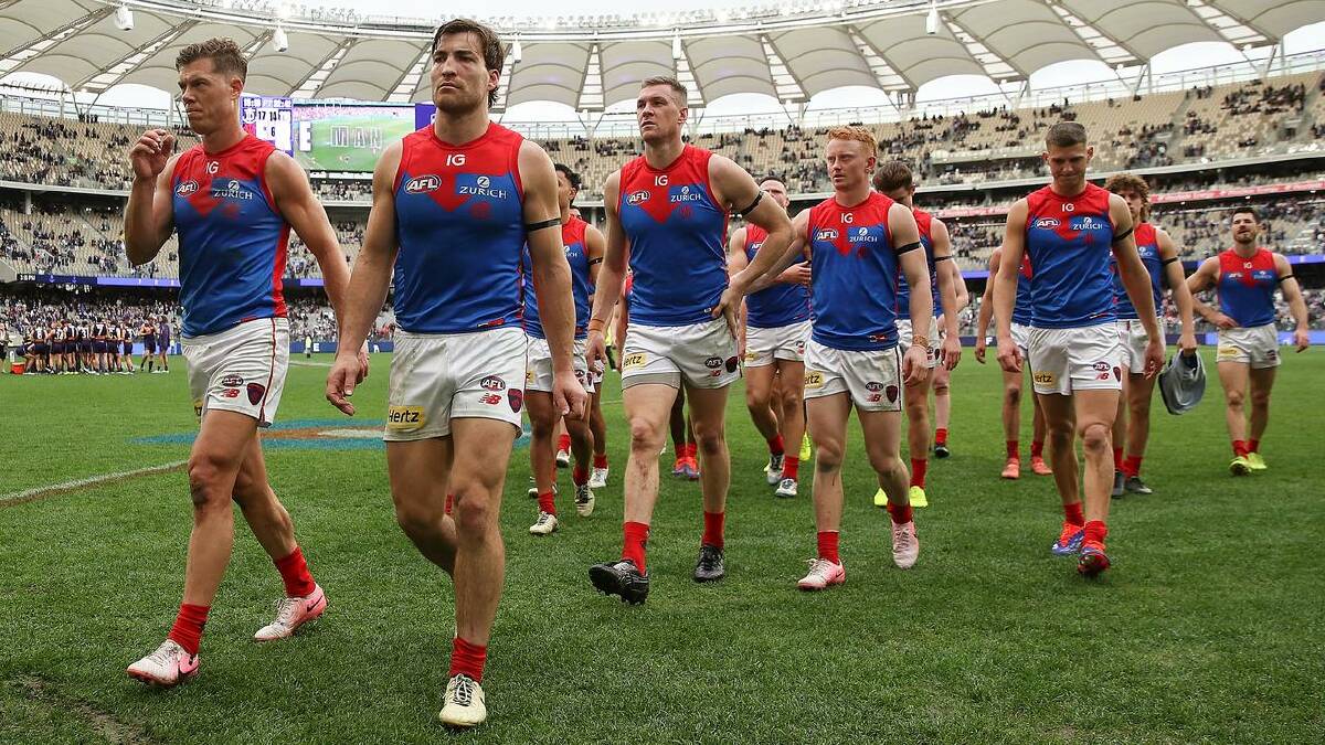 Melbourne players leave Optus Stadium after suffering a drubbing against the Dockers. (Gary Day/AAP PHOTOS)