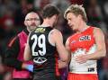 Sydney star Isaac Heeney checks on St Kilda opponent Jimmy Webster after their incident on Sunday. (Joel Carrett/AAP PHOTOS)