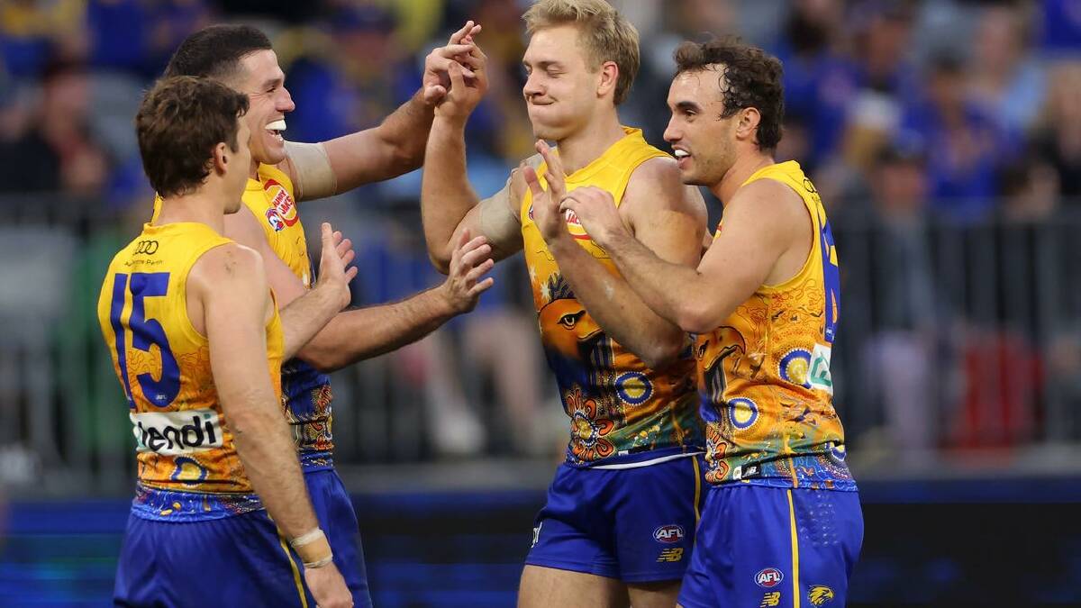 Eagles' Oscar Allen is congratulated by teammates after kicking a goal against the Lions in Perth. (Richard Wainwright/AAP PHOTOS)