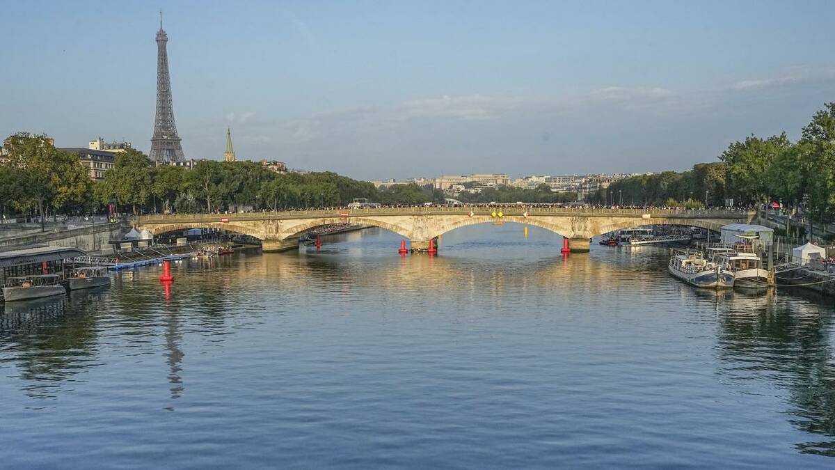 Persistent rain means the River Seine water quality remains a big issue for the Olympic triathlon. (AP PHOTO)