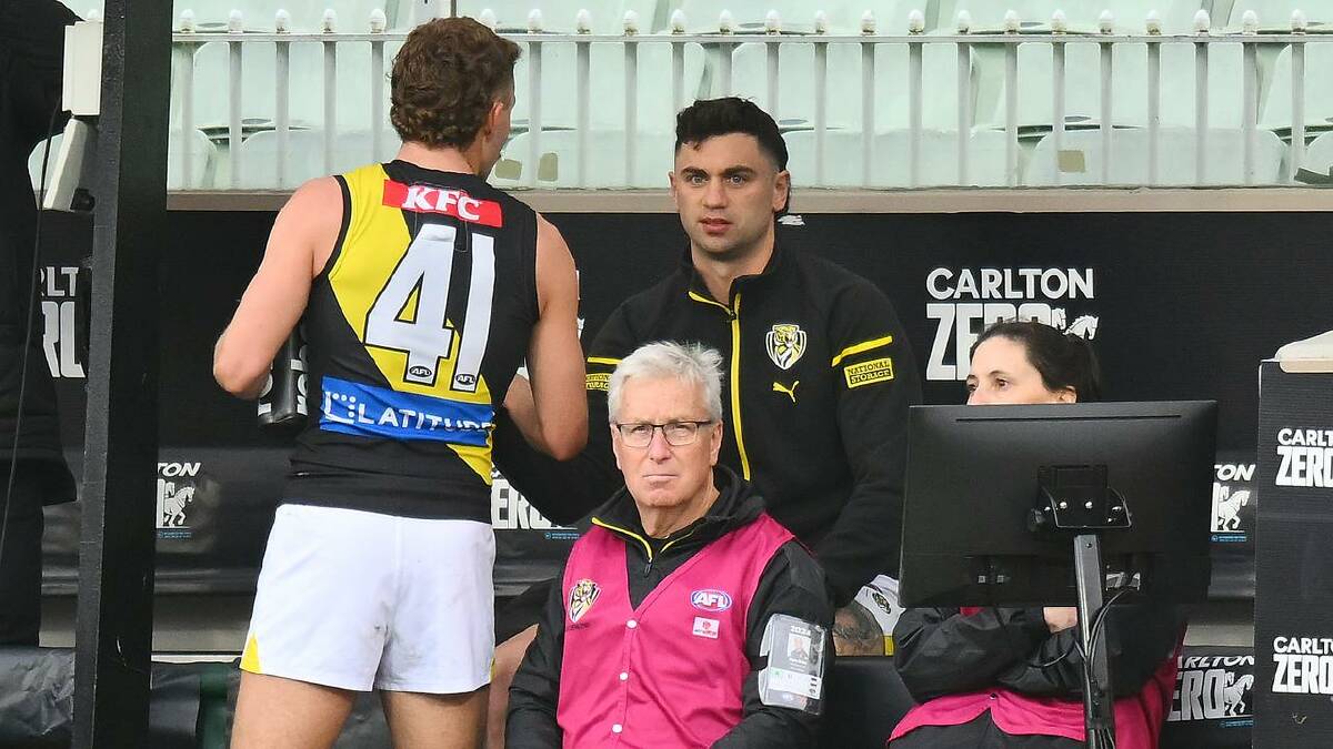 Tim Taranto watches the final quarter against the Pies seated on the Tigers bench. (Morgan Hancock/AAP PHOTOS)