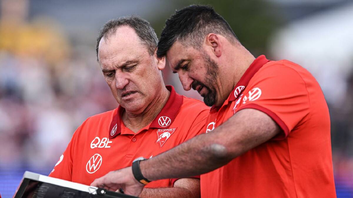 Swans coach John Longmire (L) discusses with Dean Cox what moves to make during a game. (Michael Errey/AAP PHOTOS)