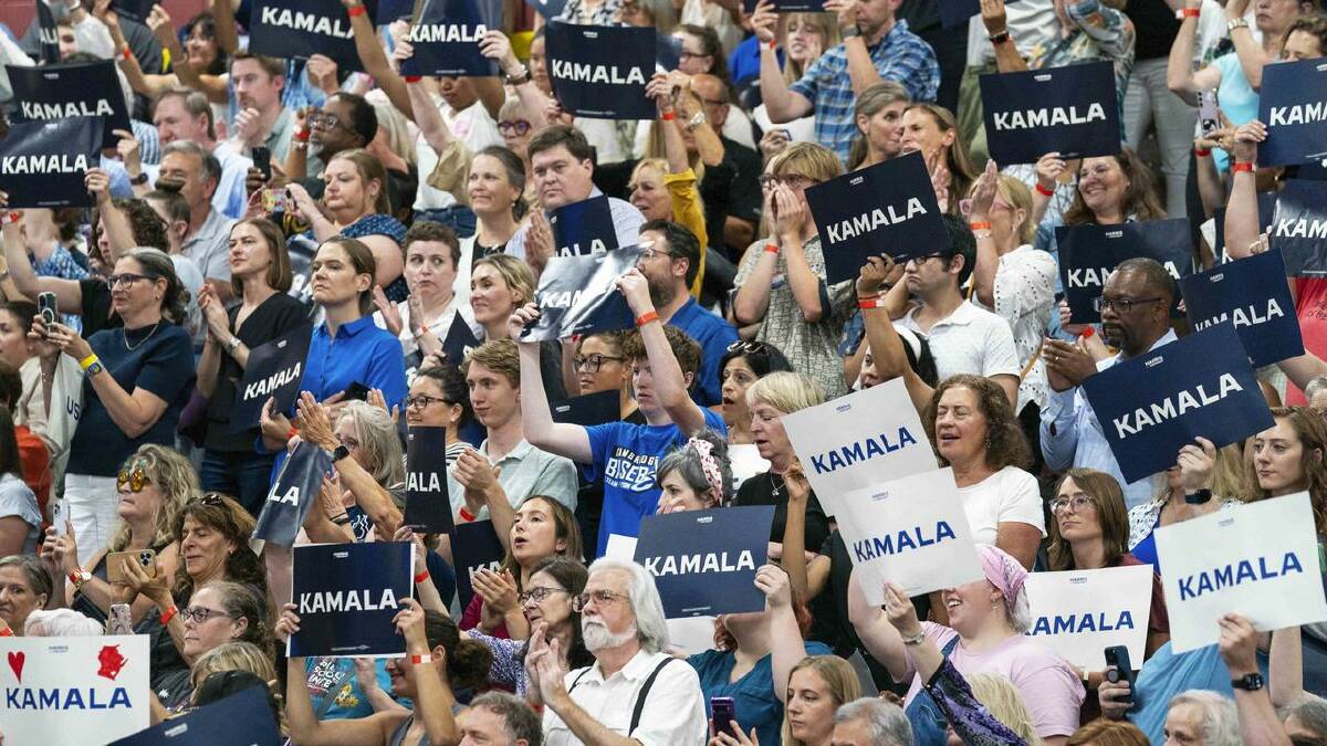 Supports hold up signs in support of Kamala Harris as she campaigned for president in Wisconsin. (AP PHOTO)