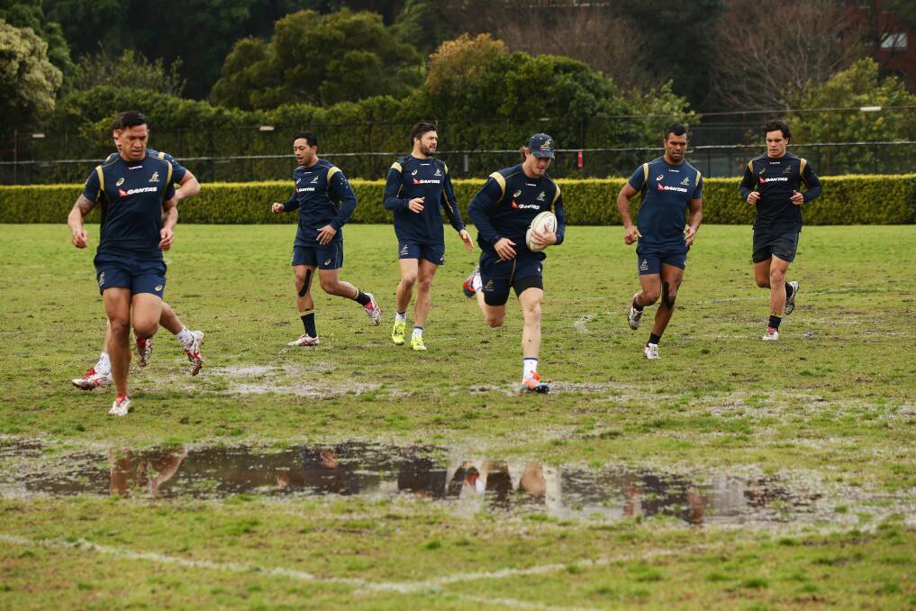 WET RUN: The Wallabies train at a sodden Sydney Grammar School yesterday. Picture: Getty Images