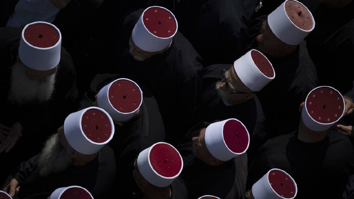 Druze clergymen attended the funeral of some of the 12 youths killed by a rocket at Golan Heights. (AP PHOTO)