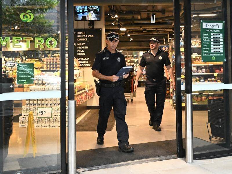 Police at the Woolworths in the Brisbane suburb of Teneriffe after it was graffitied on Monday. (Darren England/AAP PHOTOS)