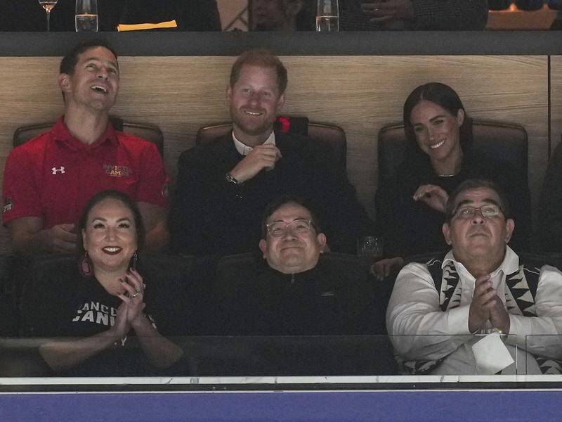 Prince Harry and Meghan Markle have been snapped in the crowd at an ice hockey game in Canada. (AP PHOTO)