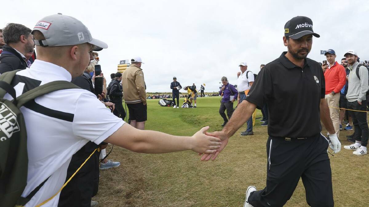 Day hand-slapping with a fan walking off the 13th green in his second round at Royal Troon. (AP PHOTO)