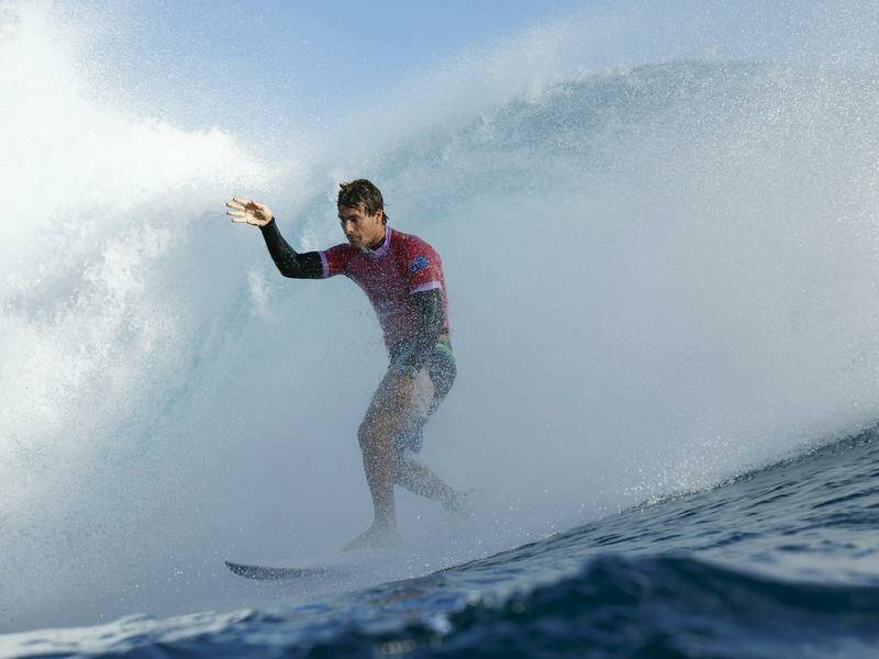 Jack Robinson waves to the crowd as he scores the best result of the Olympic surfing competition. Photo: AP PHOTO