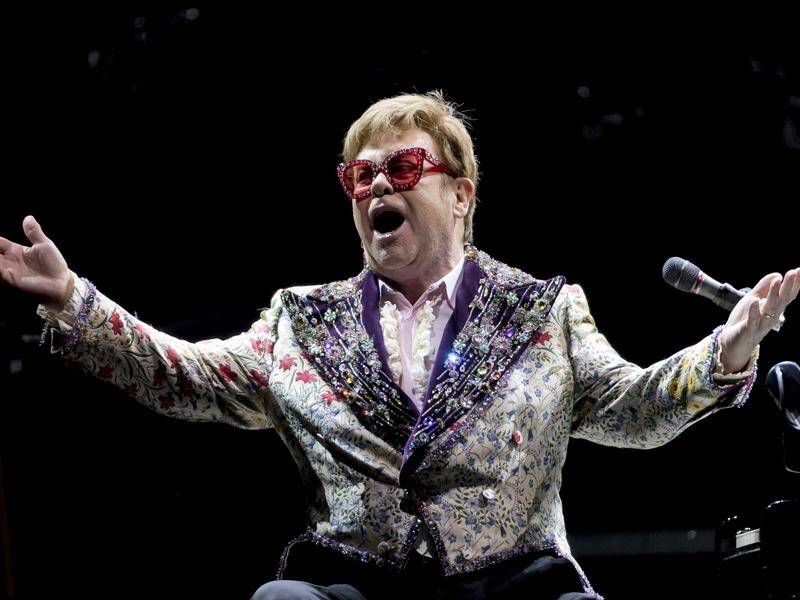 Elton John has listed the contents of his wardrobe for auction online to raise funds for charity. (AP PHOTO)