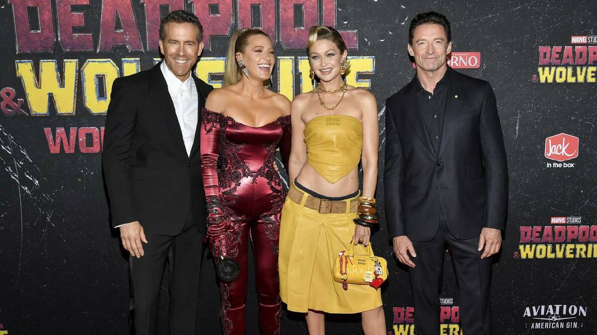Co-stars Ryan Reynolds and Hugh Jackman walked the red carpet with Blake Lively and Gigi Hadid. (AP PHOTO)