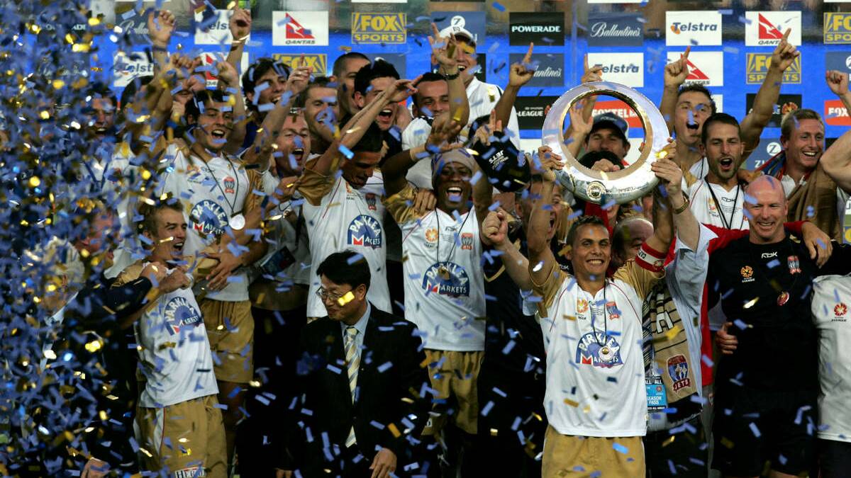 Jade North holds the trophy after the Jets won the A-League final in 2008.