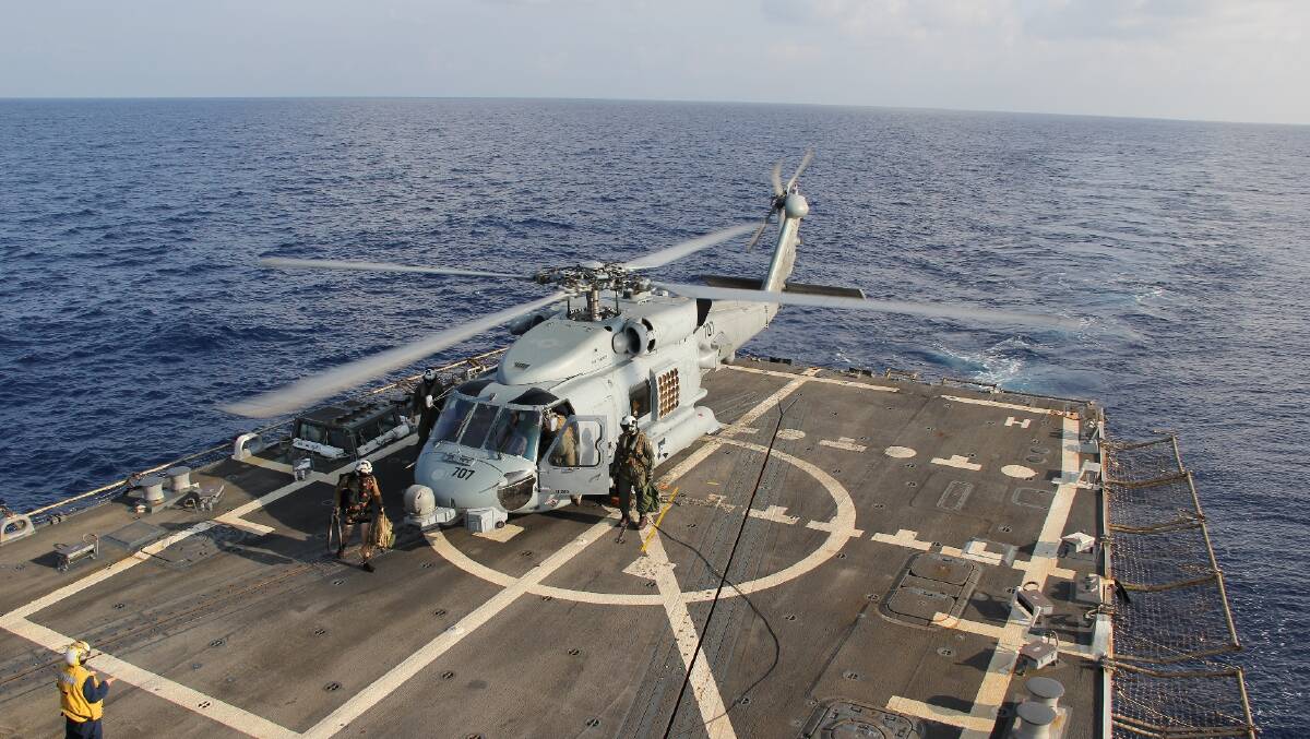 In this handout provided by the U.S. Navy, a U.S. Navy MH-60R Sea Hawk helicopter from Helicopter Maritime Strike Squadron (HSM) 78, Det 2, assigned to the guided-missile Destroyer USS Pinckney (DDG 91), lands aboard Pinckney during a crew swap before returning on task in the search and rescue for the missing Malaysian airlines flight MH370 on March 9, 2013 at sea in the Gulf of Thailand Photo: Getty Images