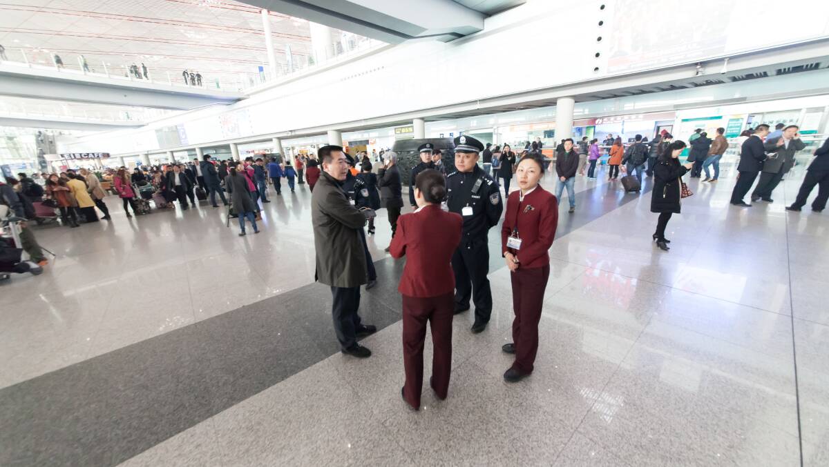 People At Beijing International Airport Wait For Malasia Airlines Flight MH370. Police and airport staffs are on the alert in case of emergency. BEIJING, CHINA - MARCH 8: Police and airport personnel mill about at Beijing International Airport March 8, 2014 in Beijing, China Photo: Getty Images