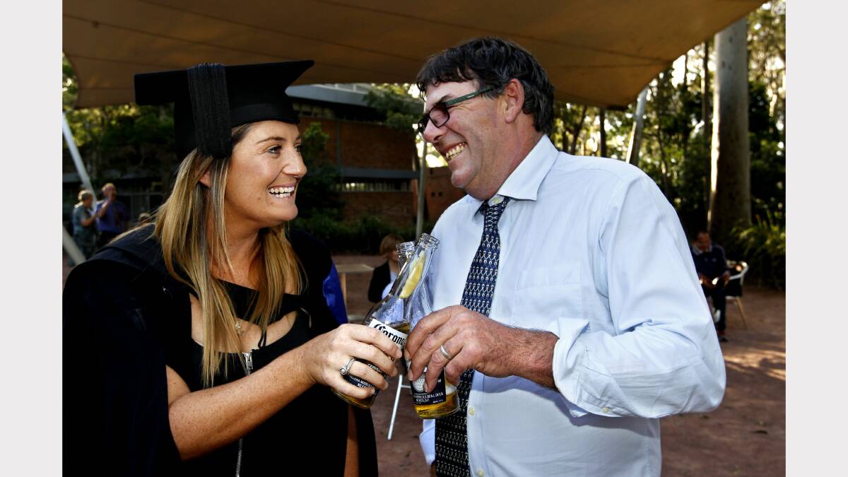 Teale Williams who graduated with a Bach of Civil Engineering celebrates with her Dad Nick Williams with a cold drink. Picture by SIMONE DE PEAK
