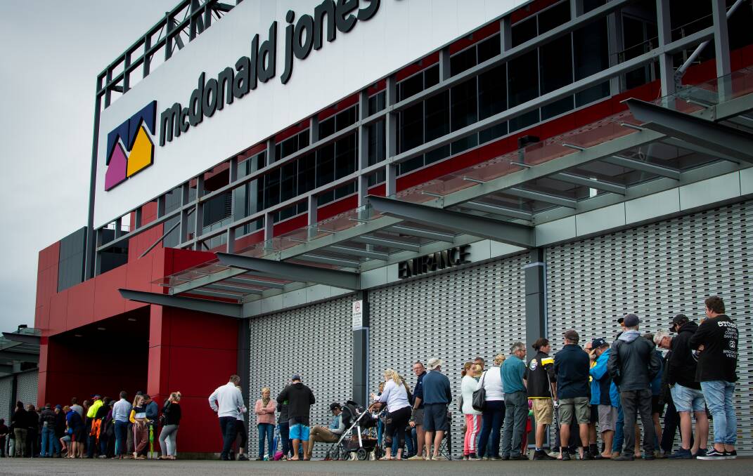 Nervous wait: Part of the line that snaked through the carpark at McDonald Jones Stadium on Monday as general public grand final tickets went on sale. Picture: Simon McCarthy