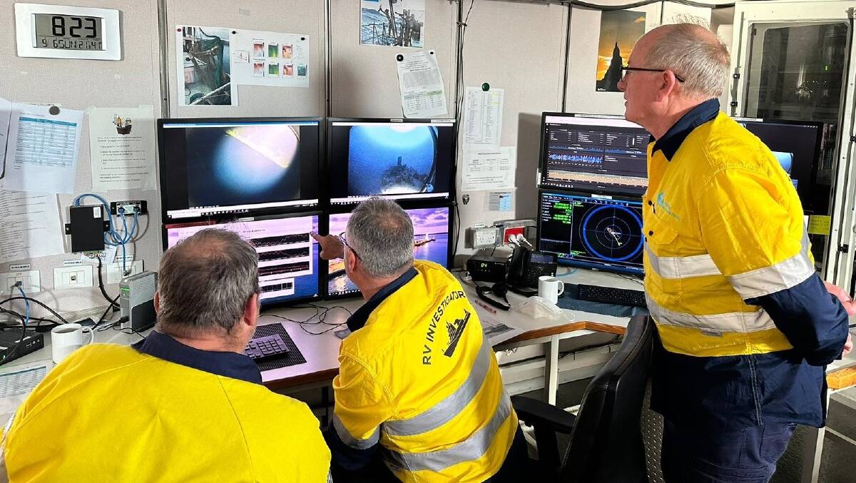 Investigators study data they retrieved. Picture supplied by CSIRO