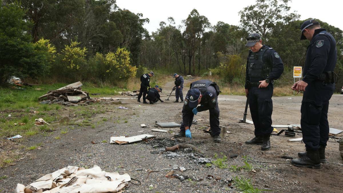 Police investigating a bikie-related shooting search for clues earlier this month at a dumping ground at Freemans Waterhole. Picture by Simone De Peak 