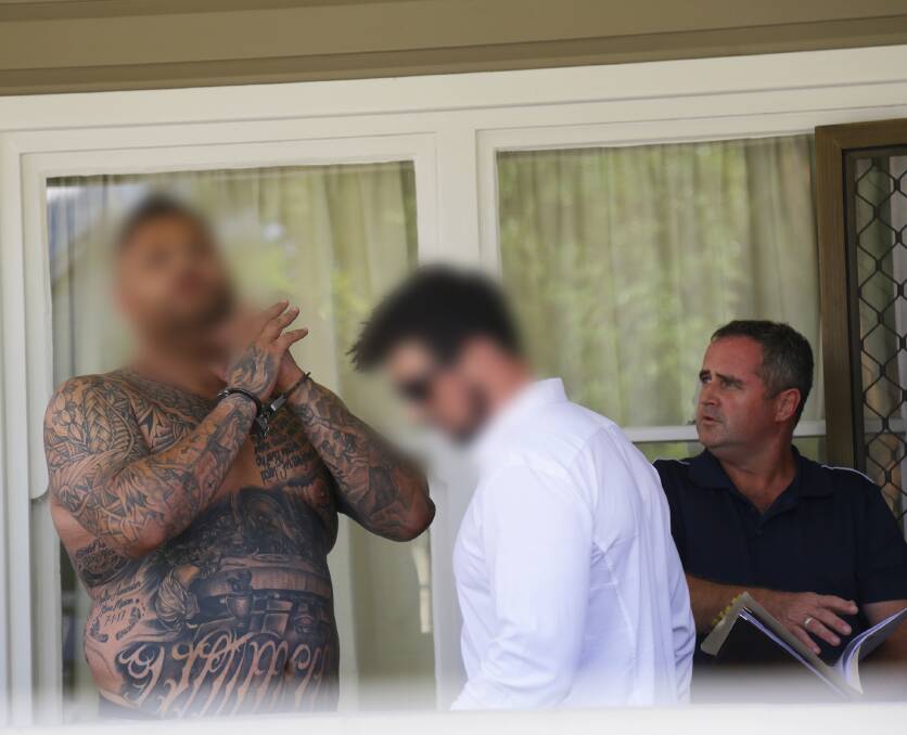 ARREST: A handcuffed Leslie Charles Mason with detectives outside of his Mayfield home on Wednesday. He has been charged with supplying a large commercial quantity of Butanediol. Picture: NSW Police 