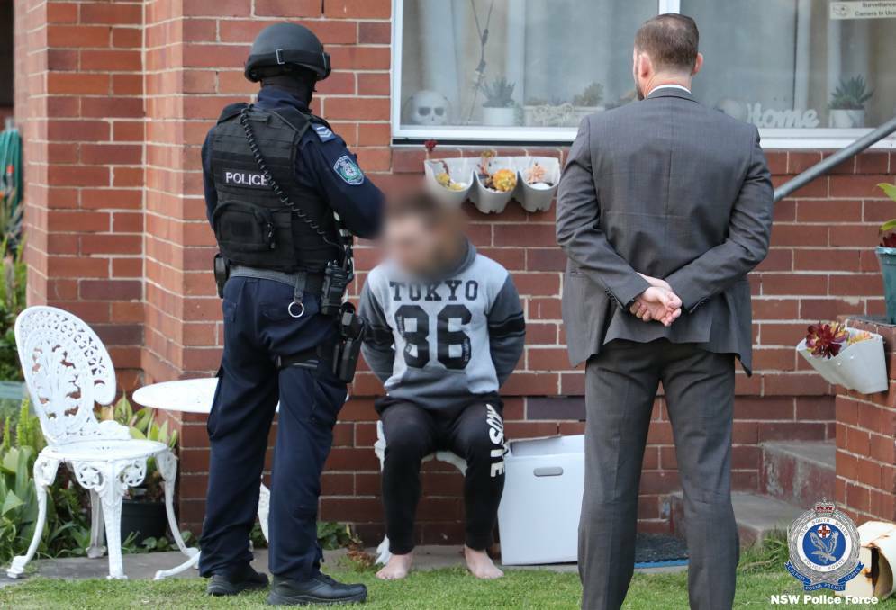 Detectives arrest Dalton Trent Oliver at a home in Pitt Street, Stockton in October last year over the murder of Graham Cameron in July, 2021. Picture by NSW Police 